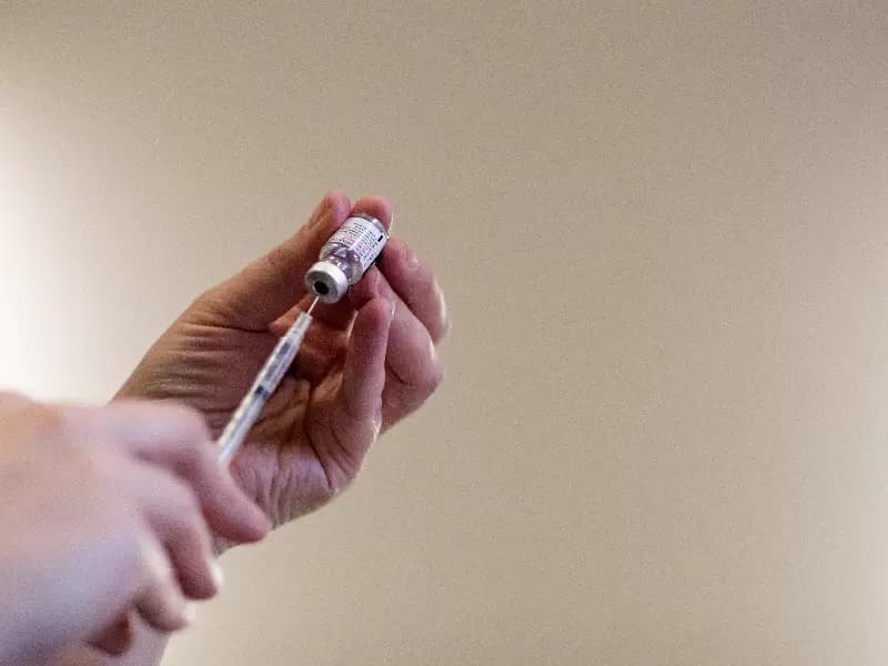 A nurse fills up syringes with the coronavirus disease (COVID-19) vaccines for residents who are over 50 years old and immunocompromised and are eligible to receive their second booster shots in Waterford, Michigan, U.S., April 8, 2022.