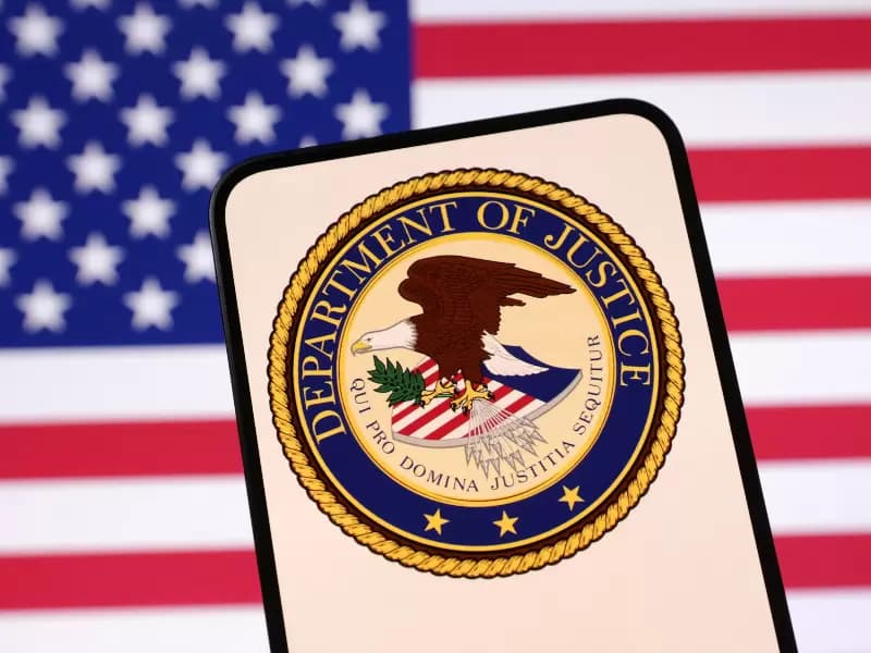 United States Department of Justice logo and U.S. flag are seen in this illustration taken April 23, 2025.