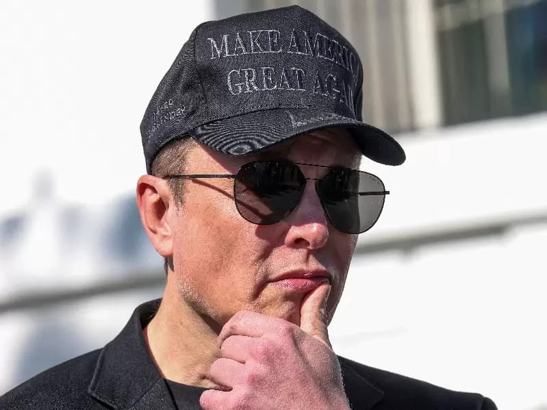 FILE PHOTO: Tesla CEO Elon Musk looks on next to U.S. President Donald Trump talking to the media, at the White House in Washington, D.C., U.S., March 11, 2025.