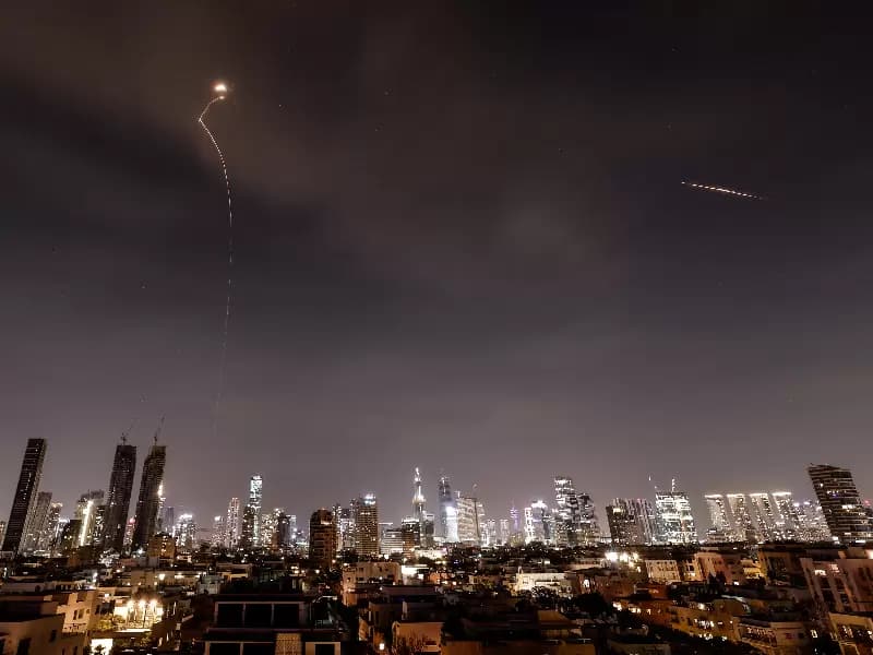 Streaks of light illuminate the sky during an interception attempt amid the U.S.-Israeli conflict with Iran, as seen from Tel Aviv, Israel, March 23, 2026.