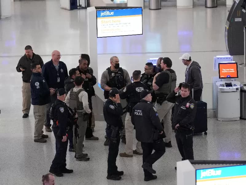 Immigration and Customs Enforcement (ICE) agents stand with other Law enforcement at John F. Kennedy International Airport, New York City, U.S. March 23, 2026. Hundreds of Immigration and Customs Enforcement agents were ordered to deploy to airports to help fill TSA staffing gaps across the country.