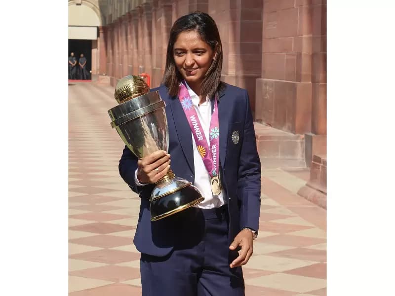 Indian Women's Cricket team captain Harmanpreet Kaur with the ICC Women’s Cricket World Cup trophy during her visit to Rashtrapati Bhavan after their title win, in New Delhi on November 6, 2025.