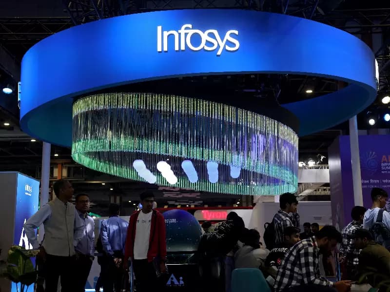 Visitors stand at the Infosys kiosk at Bharat Mandapam, one of the venues for AI Impact Summit, in New Delhi, India, February 18, 2026.