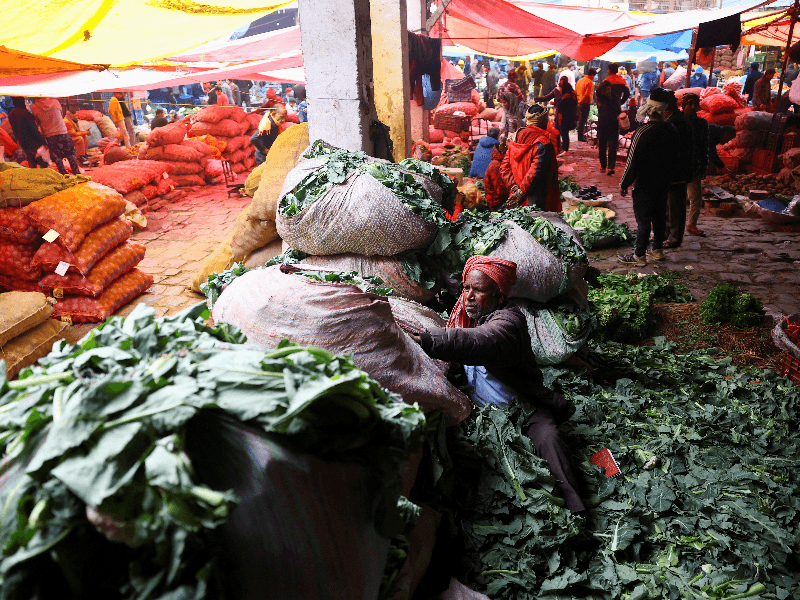 A man sorts vegetables at a wholesale fruit and vegetable market in the old quarters of Delhi, India, February 1, 2026.