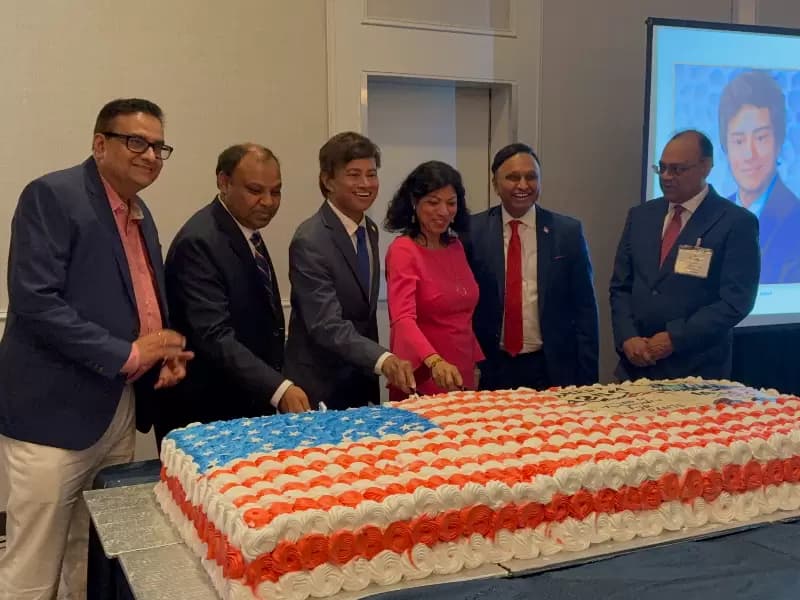 Rep. Shri Thanedar cutting the cake at the ceremony