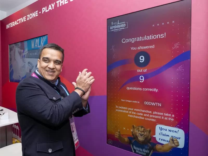 Harsh Sanghavi taking a sports quiz at the Amdavad Experience Centre in Glasgow