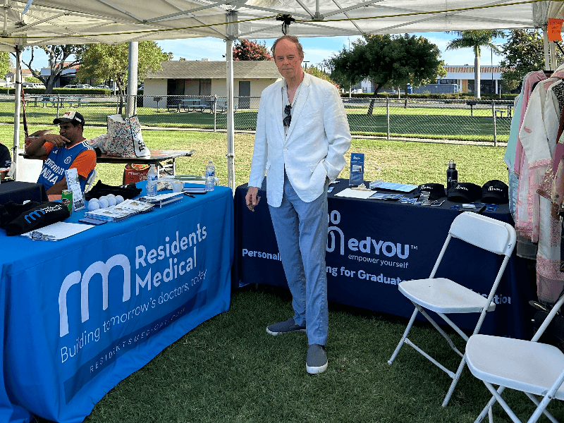 Greg Heffernan, VP of Academic Affairs at Residents Medical, at the organization's booth during the Indian Independence Day Mela in Artesia, California.